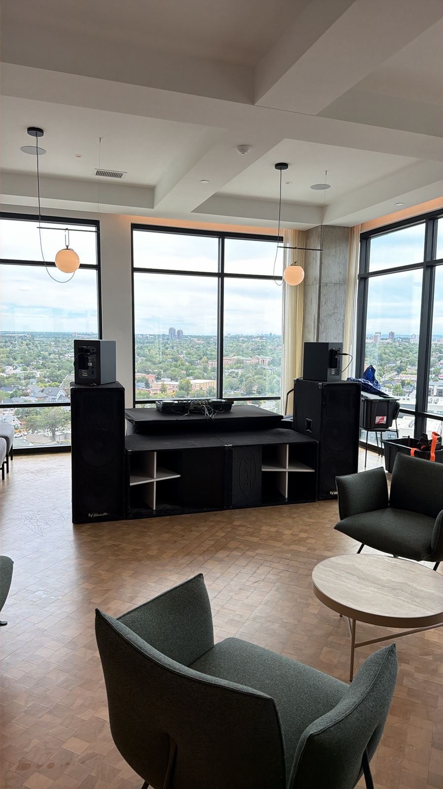 A rooftop lounge set up for a daytime event with the rig in front of floor-to-ceiling windows